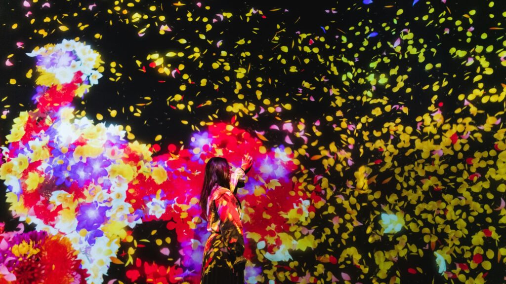Woman Touching Magical Falling Flowers 4K Desktop Wallpaper