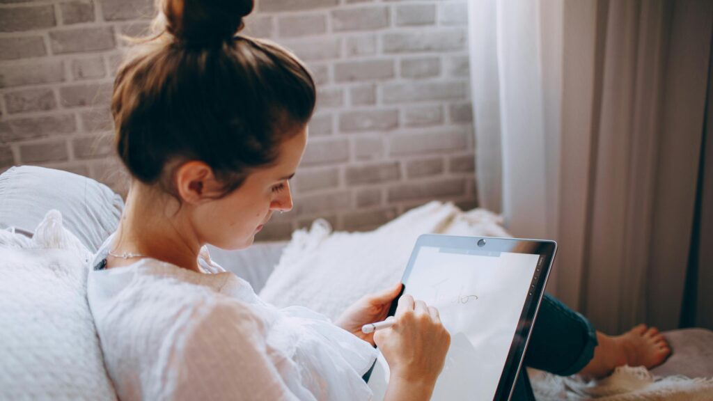 Woman Writing a To-Do List on a Digital Tablet 4K Desktop Wallpaper