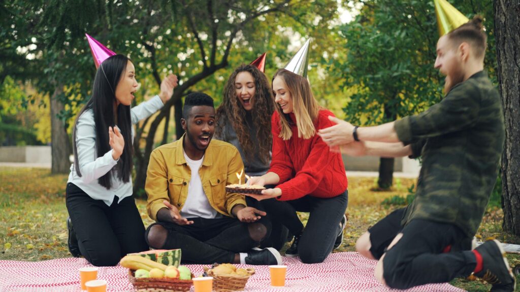 Friends Celebrating Birthday Outdoors Picnic Party 4K Wallpaper