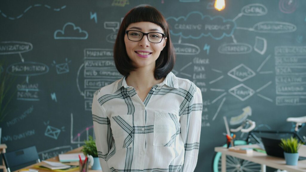 Professional Business Woman Smiling in Modern Creative Office 4K Wallpaper