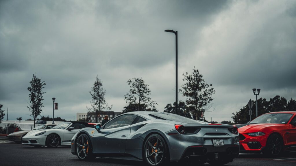 Stunning Silver Ferrari 488 Supercar in Rainy Parking Lot 4K Wallpaper