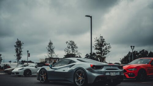 Stunning Silver Ferrari 488 Supercar in Rainy Parking Lot 4K Wallpaper