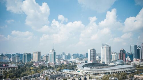 Stunning Aerial View of Cityscape with Modern Stadium Desktop Wallpaper
