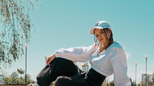 Stylish Young Woman in White Hoodie and Baseball Cap PC Wallpaper