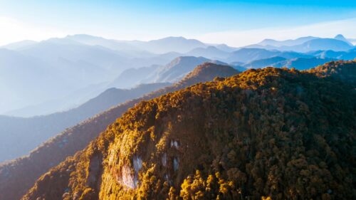 Golden Sunlight on Lush Mountain Peaks 4K Desktop Wallpaper