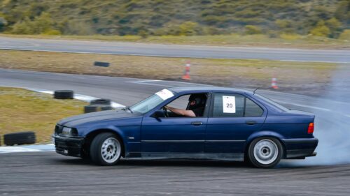 Blue BMW E36 Drift Car Racing on Track 4K Desktop Wallpaper