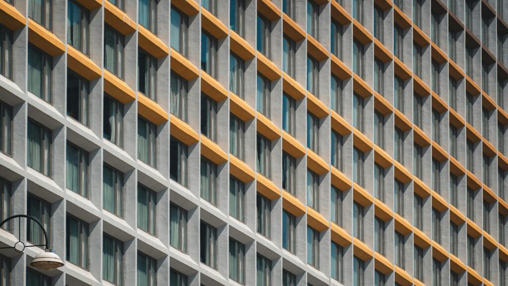 Modern Architectural Facade Grid with Golden Accents Desktop Wallpaper