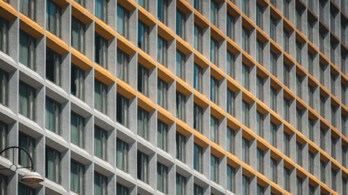 Modern Architectural Facade Grid with Golden Accents Desktop Wallpaper