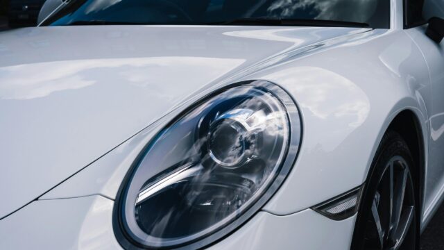 White Porsche 911 Sports Car Headlight Closeup 4K Desktop Wallpaper