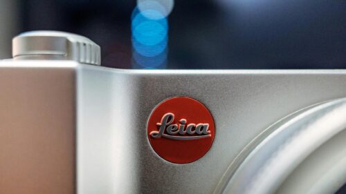 Close-up of Iconic Leica Camera Logo Silver Finish 4K Wallpaper