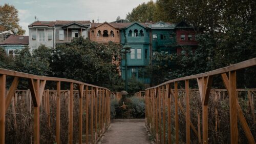 Charming Colorful Row Houses Behind a Wooden Garden Bridge Desktop Wallpaper