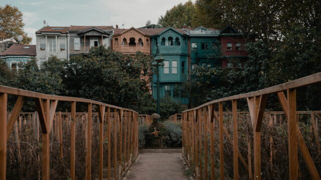 Charming Colorful Row Houses Behind a Wooden Garden Bridge Desktop Wallpaper
