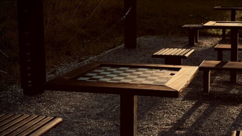 Rustic Outdoor Chess Table at Sunset Cinematic Desktop Wallpaper