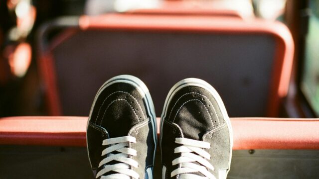 Black Vans Sneakers on Bus Seat Close-up Desktop Wallpaper