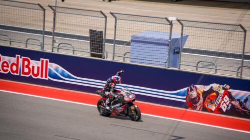 Moto2 Rider Celebrating Victory on Track 4K Desktop Wallpaper
