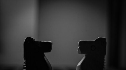 Two Minimalist Chess Knight Silhouettes Facing Off Desktop Wallpaper