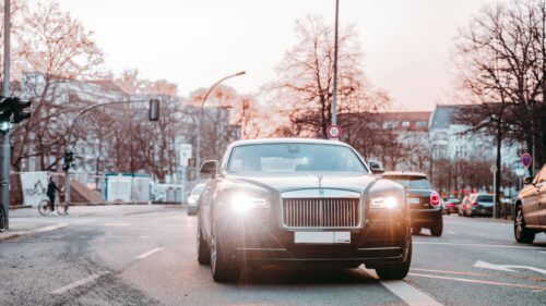 Luxurious Rolls-Royce Wraith Driving on City Street Desktop Wallpaper