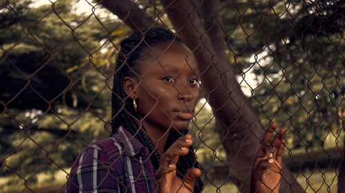 Young Woman Behind Chain Link Fence Moody Portrait 4K Wallpaper