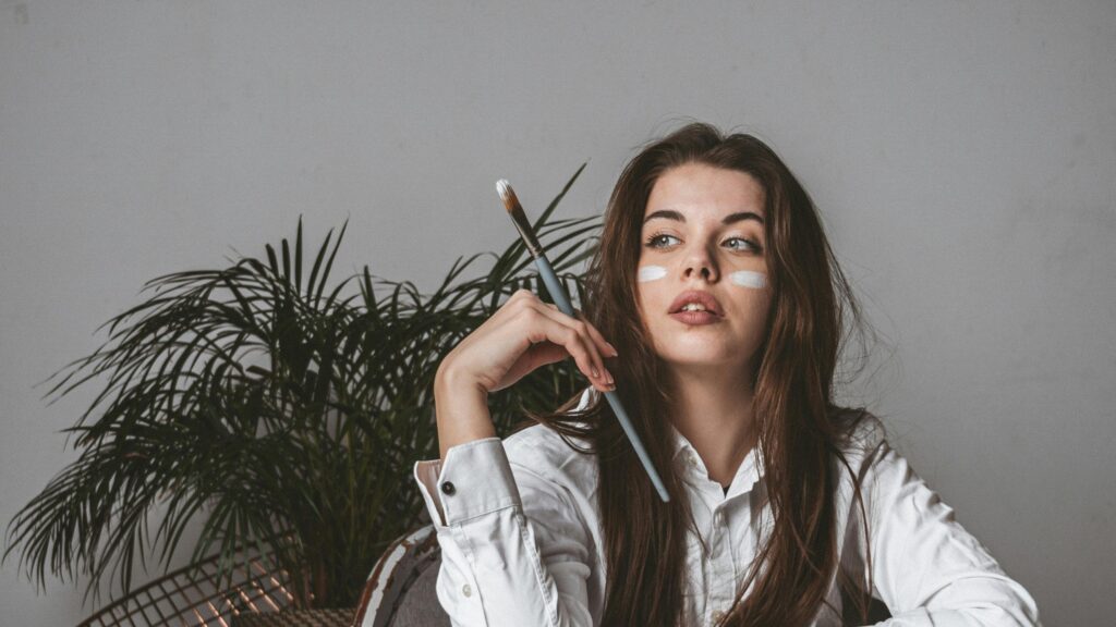 Artistic Girl With Paintbrush and White Makeup 4K Desktop Wallpaper