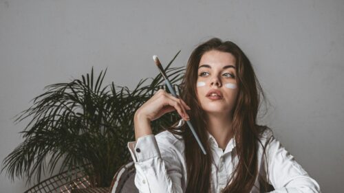 Artistic Girl With Paintbrush and White Makeup 4K Desktop Wallpaper
