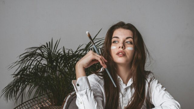 Artistic Girl With Paintbrush and White Makeup 4K Desktop Wallpaper
