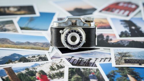 Vintage Elite Camera Surrounded by Travel Memories 4K Wallpaper