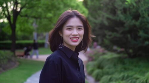 Beautiful Young Asian Woman Smiling in a Park 4K Desktop Wallpaper
