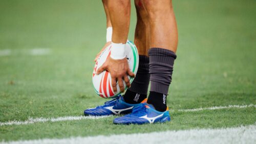 Rugby Player Preparing for Kickoff on Grass Field 4K Wallpaper