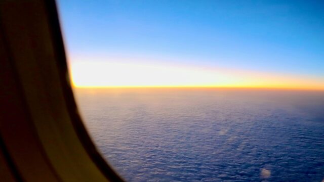 Breathtaking Airplane Window View Above Clouds at Sunrise 4K Wallpaper