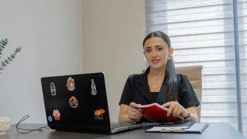 Professional Woman Working at Desk with Laptop PC Wallpaper