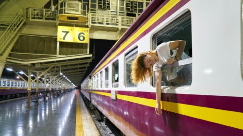 Woman Looking Out of Vintage Train Window at Night Station Desktop Wallpaper