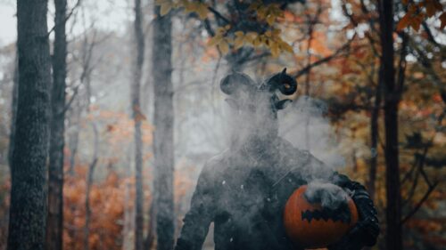 Eerie Horned Demon with Pumpkin in Misty Autumn Forest 4K Wallpaper