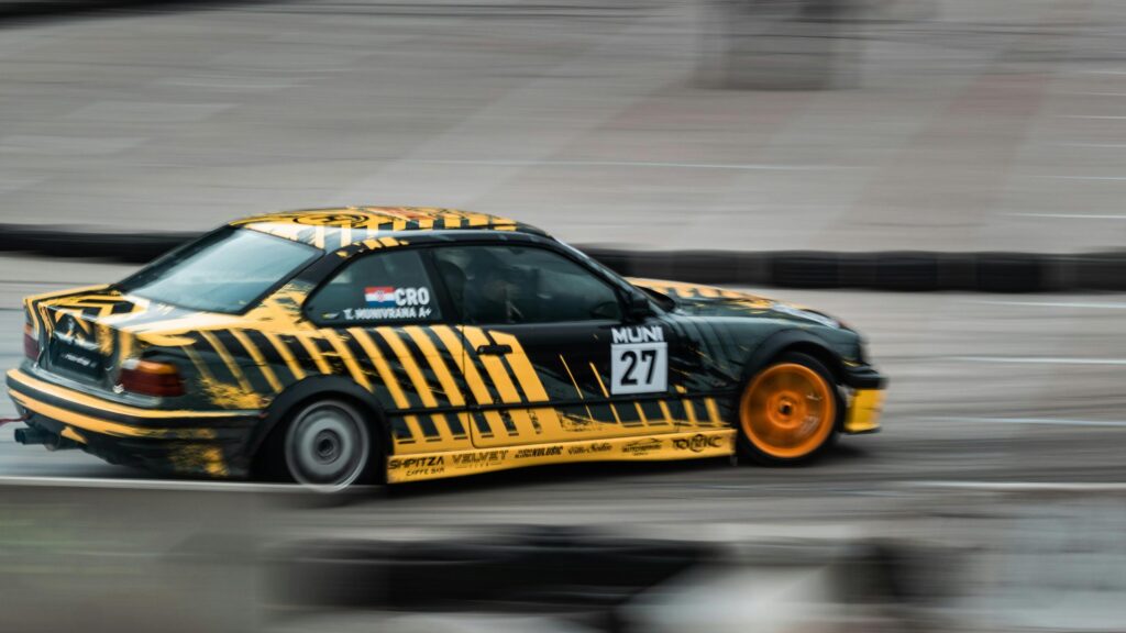 Drifting BMW E36 Yellow and Black Rally Race Car Desktop Wallpaper