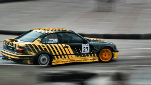 Drifting BMW E36 Yellow and Black Rally Race Car Desktop Wallpaper
