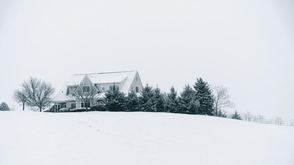 Serene Snow Covered House on a Hill 4K Desktop Wallpaper