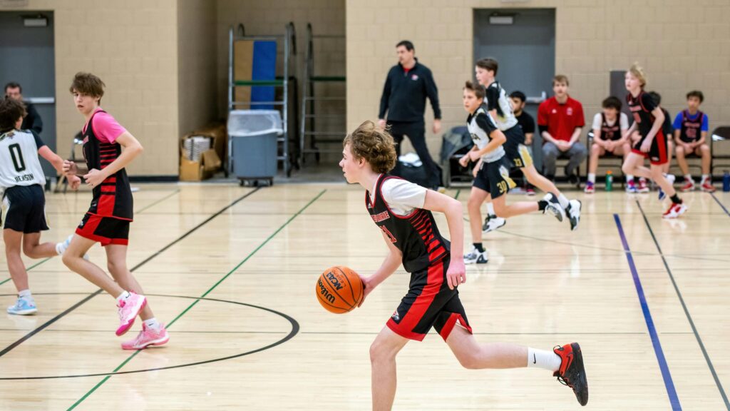 Young Basketball Players in Action on Court 4K Desktop Wallpaper