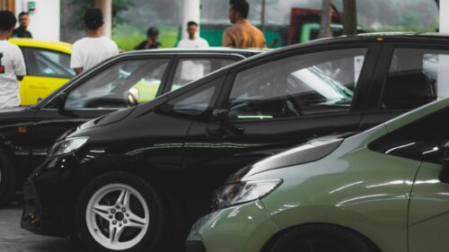 Close-Up of Modern Black and Green Hatchback Cars at Auto Show 4K Wallpaper