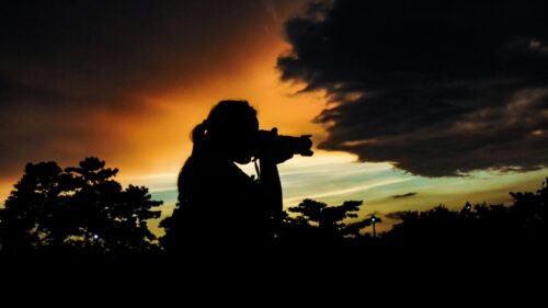 Photographer Silhouette Against Golden Hour Sunset Desktop Wallpaper