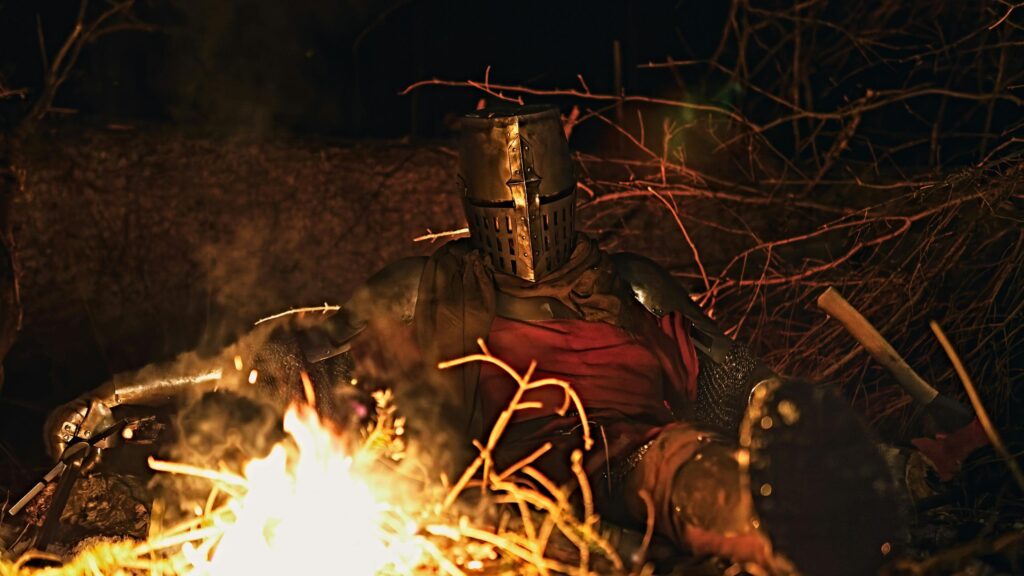 Knight Resting by a Campfire in the Dark Forest 4K Wallpaper