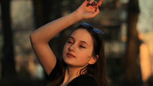 Dreamy Young Woman in Golden Hour Sunlight 4K Wallpaper