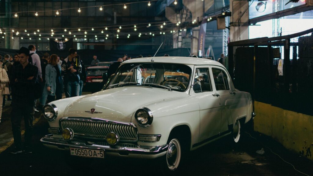 Classic White GAZ Volga Vintage Car in Industrial Exhibition Desktop Wallpaper