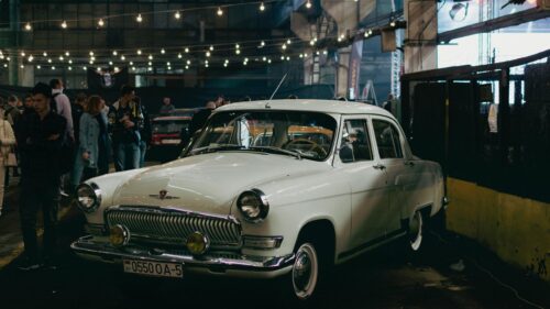 Classic White GAZ Volga Vintage Car in Industrial Exhibition Desktop Wallpaper