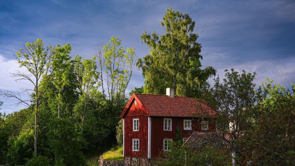 Rustic Red Swedish Cottage in Lush Summer Forest 4K Wallpaper