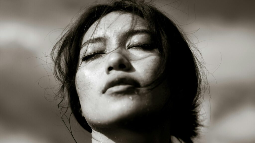 Dramatic Close-up Portrait of a Woman with Wet Skin 4K Wallpaper