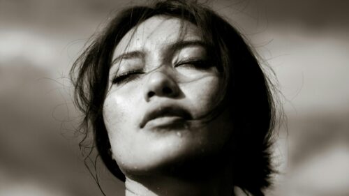 Dramatic Close-up Portrait of a Woman with Wet Skin 4K Wallpaper