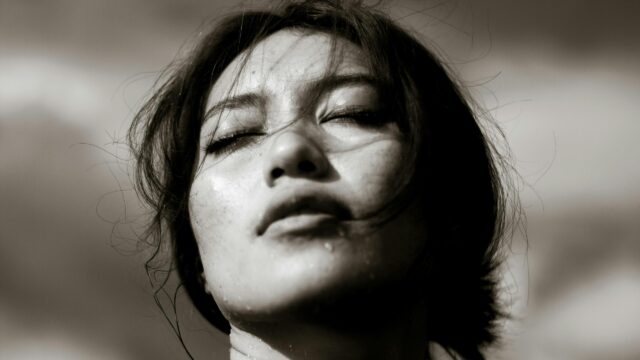 Dramatic Close-up Portrait of a Woman with Wet Skin 4K Wallpaper
