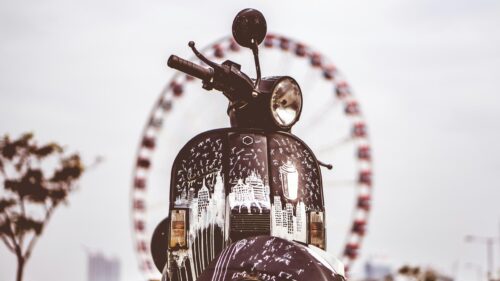 Black Scooter with White Street Art and Ferris Wheel Desktop Wallpaper