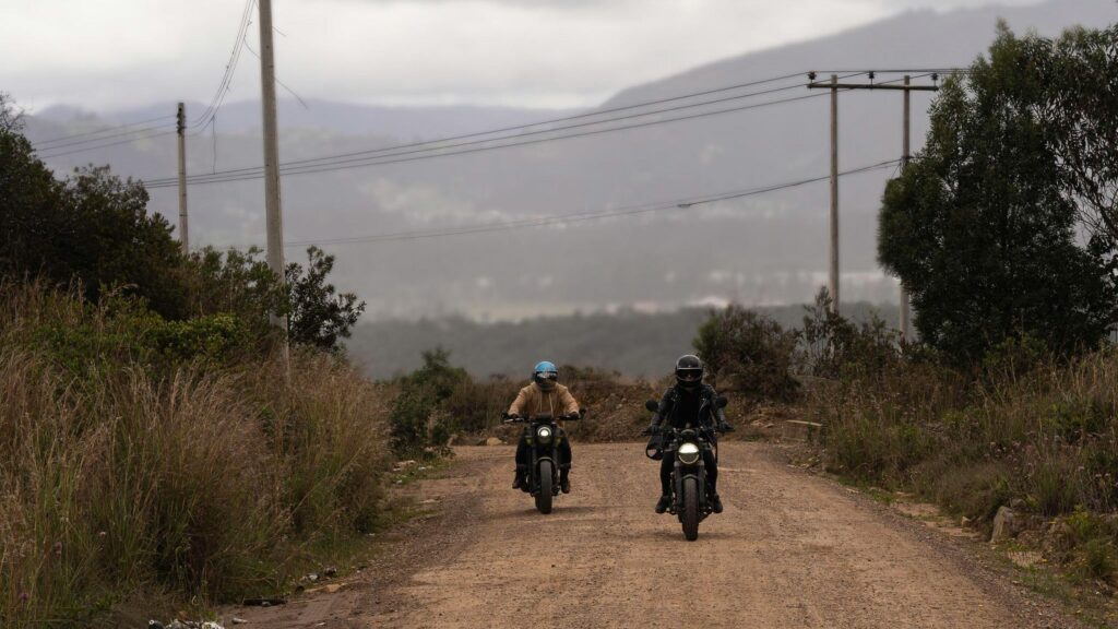 Two Motorcyclists Riding on a Dusty Rural Trail 4K Wallpaper
