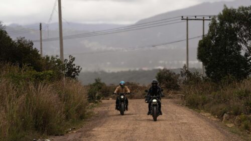 Two Motorcyclists Riding on a Dusty Rural Trail 4K Wallpaper
