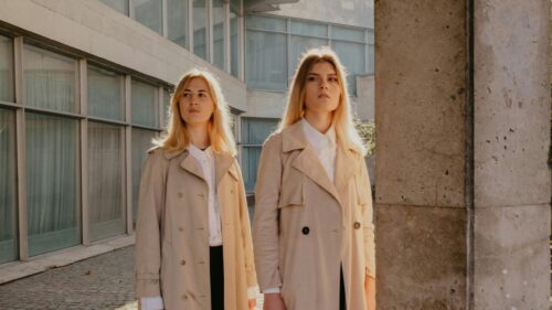 Two Stylish Blonde Women in Beige Trench Coats Fashion Desktop Wallpaper